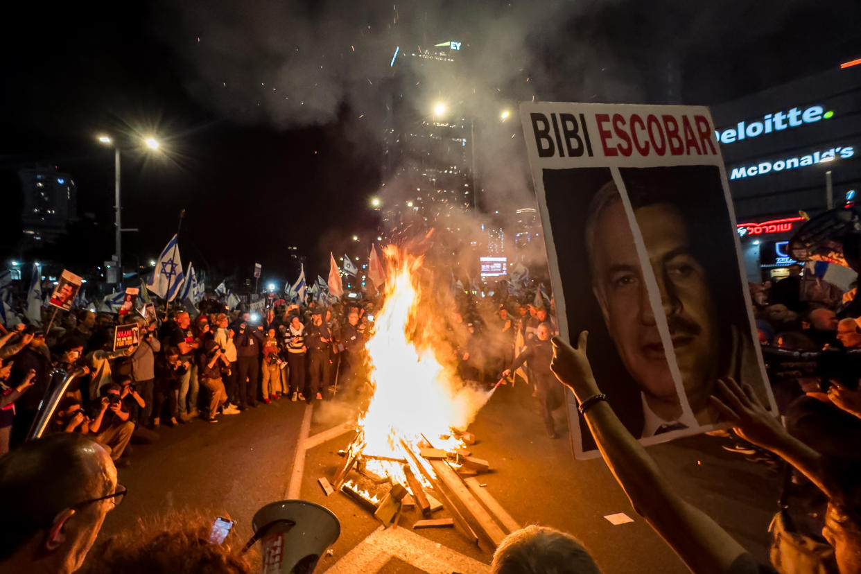 Protesters chant around a fire during a protest demanding the release of hostages still held in Gaza and against the government of Israeli Prime Minister Benjamin Netanyahu, outside The Kirya, the area where Israel's armed forces have their headquarters, March 16, 2024, in Tel Aviv, Israel. / Credit: Alexi J. Rosenfeld/Getty