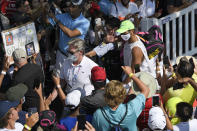 Rafael Nadal, of Spain, waves as he tries to get by fans after a practice session at the Citi Open tennis tournament, Thursday, Aug. 5, 2021, in Washington. (AP Photo/Nick Wass)