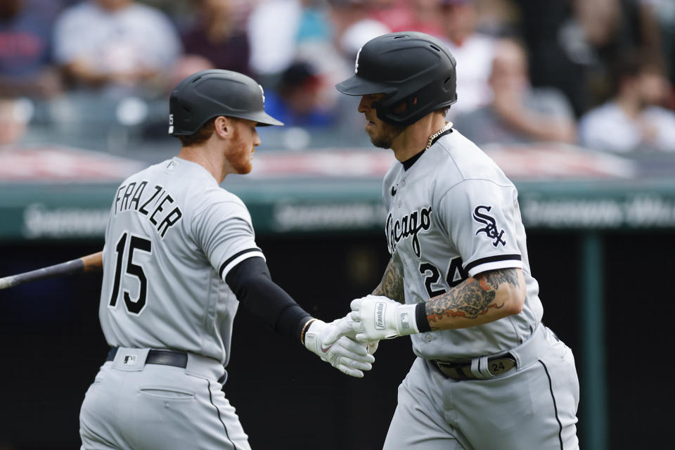 Chicago White Sox's Yasmani Grandal celebrates with Clint Frazier (15) after hitting a solo home run off Cleveland Guardians starting pitcher Logan Allen during the fifth inning of a baseball game, Tuesday, May 23, 2023, in Cleveland. (AP Photo/Ron Schwane)