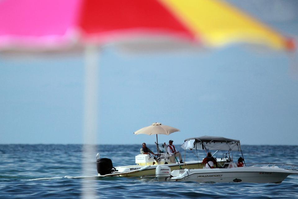 Boaters are pictured from the beach on June 27, 2010 in Orange Beach, Alabama.