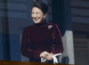 Japan's Crown Princess Masako smiles from the balcony during the New Year's public appearance to well-wishers with Japan's Emperor Akihito's family members at Imperial Palace in Tokyo Wednesday, Jan. 2, 2019. Akihito waved Wednesday to throngs of well-wishers eager to see the final New Year’s appearance in his reign. (AP Photo/Eugene Hoshiko)