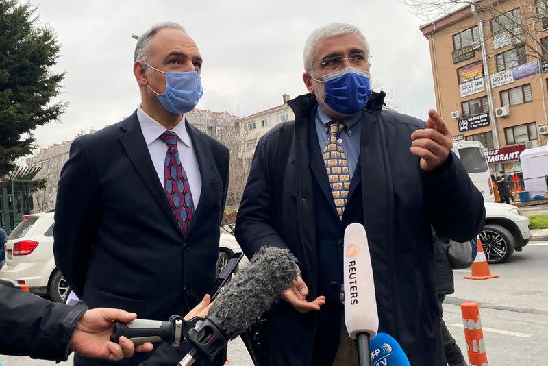 Turkish pilot Noyan Pasin and his lawyer Erem Yucel talk to media outside a courthouse in Istanbul