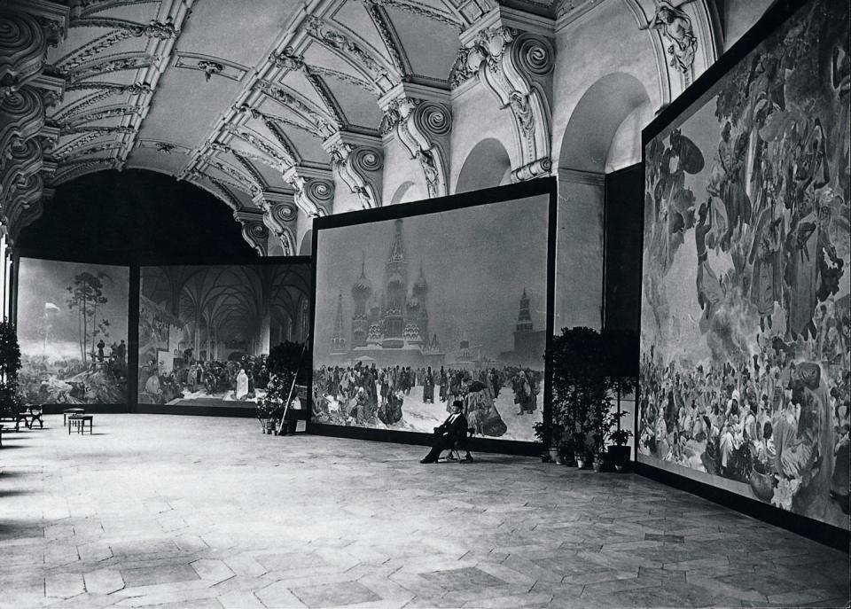 Mucha with the Slav Epic canvases as exhibited in the Klementinum, Prague, 1919 © Mucha Trust 2024.