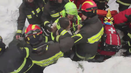 Firefighters rescue a survivor from Hotel Rigopiano in Farindola, central Italy, hit by an avalanche, in this handout picture released on January 20, 2017 provided by Italy's Fire Fighters. Vigili del Fuoco/Handout via REUTERS