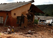 Children play outside a house destroyed by Cyclone Idai in Chimanimani, Zimbabwe March 22, 2019. REUTERS/Philimon Bulawayo