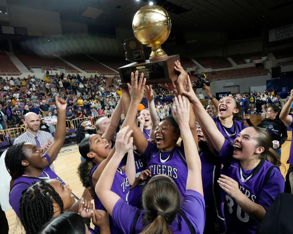 Mar 1, 2022; Phoenix, Ariz., U.S.;  Millennium players celebrate their 5A state girls basketball championship against Flowing Wells at Arizona Veterans Memorial Coliseum. Mandatory Credit: Michael Chow-Arizona Republic