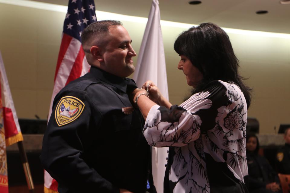 Christopher Fariello's badge is pinned by a family member in 2019 when he was sworn in as one of 11 new Tallahassee Police officers.