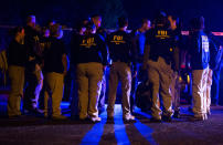 <p>FBI agents meet at the scene of an explosion in Austin, Texas, Sunday, March 18, 2018. At least a few people were injured in another explosion in Texas’ capital late Sunday, after three package bombs detonated this month in other parts of the city, killing two people and injuring two others. (Photo: Nick Wagner/Austin American-Statesman via AP) </p>