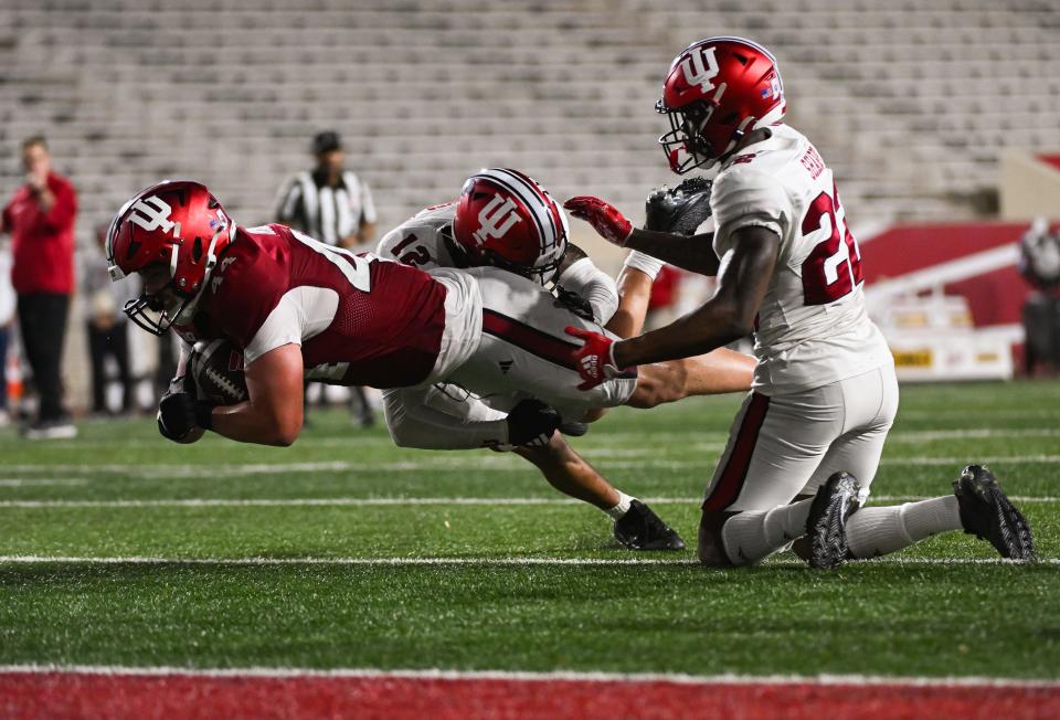 Indiana Hoosiers tight end Zach Horton (44) runs after a catch against Indiana Hoosiers defensive back Terry Jones Jr (12) during the Indiana football spring game at Memorial Stadium on Thursday, 18 April 2024.