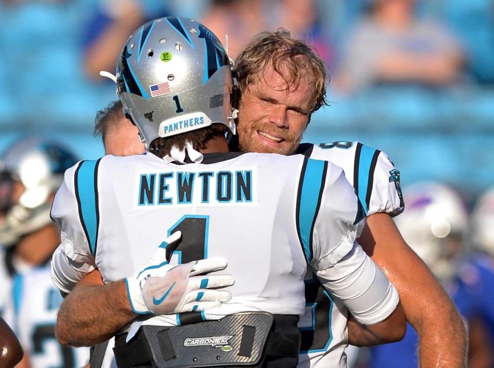 Carolina Panthers tight end Greg Olsen smiles as he is hugged by quarterback Cam Newton in 2019.