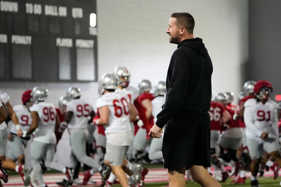 Mar 5, 2024; Columbus, OH, USA; Ohio State Buckeyes offensive coordinator Brian Hartline watches players warm up during the first spring practice at the Woody Hayes Athletic Center.