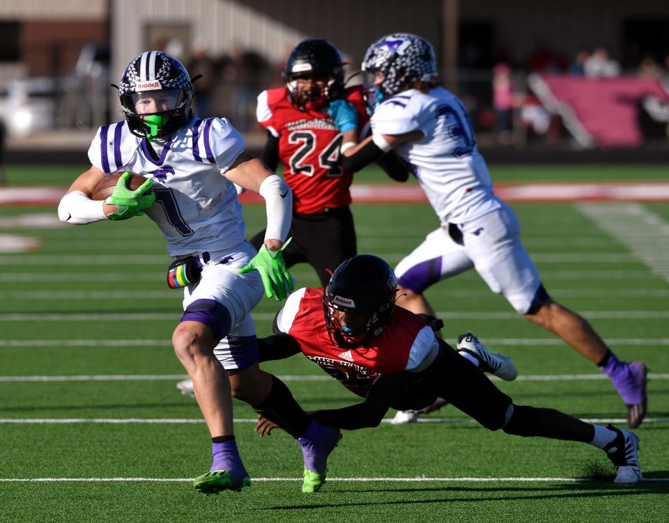 Benjamin running back Grayson Rigdon eludes Whitharral defensive back Shamadrick Weaver during the Class 1A Division II six-man semifinal playoff Dec. 3 in Hermleigh.