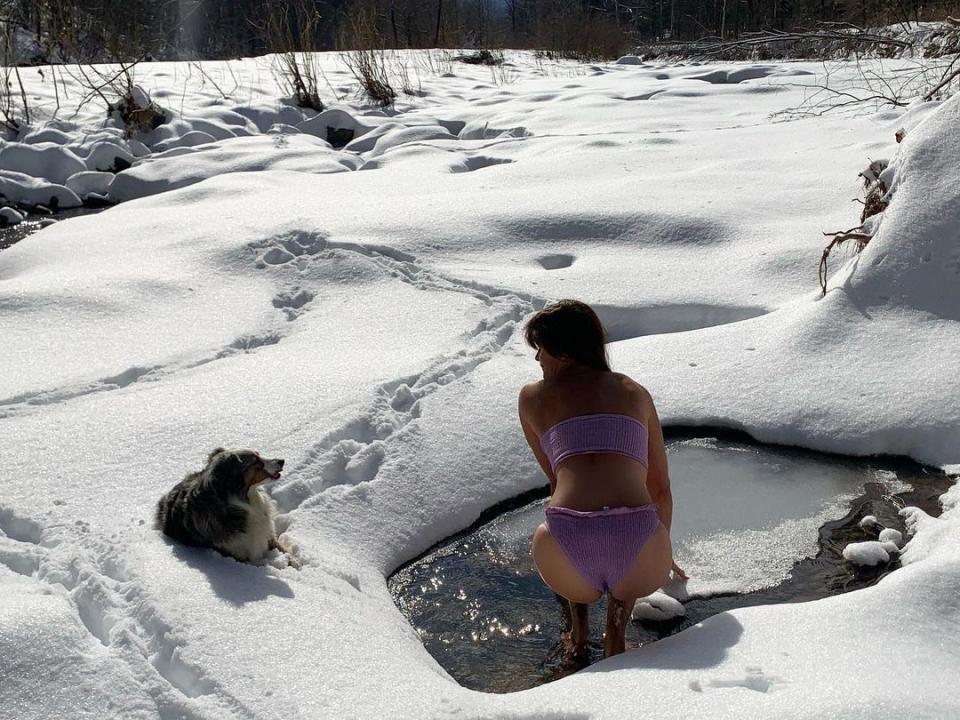 Helena Christensen sits in icy water in her bikini
