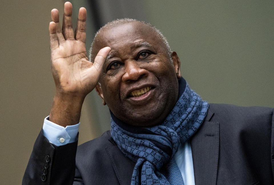 Former Ivory Coast president Laurent Gbagbo greets supporters attending the court session at the International Criminal Court in The Hague, Netherlands, Thursday, Feb. 6, 2020. Gbagbo is scheduled to return home to Ivory Coast Thursday June 17, 2021 for the first time in nearly a decade. The move comes after his acquittal on war crimes charges was upheld at the International Criminal Court earlier this year. (AP Photo/Jerry Lampen, Pool)