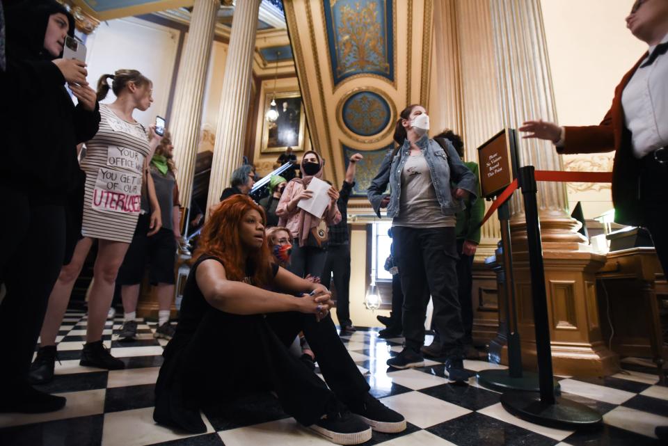 Pro-choice advocates, including Zora Monico, 24, seated, of Detroit, rally outside the State House floor Wednesday afternoon, June 8, 2022, demanding the release of a protester taken into police custody. They were demanding the repeal of the 1931 Michigan abortion ban. The event was organized by the Michigan Coalition for Reproductive Liberation.