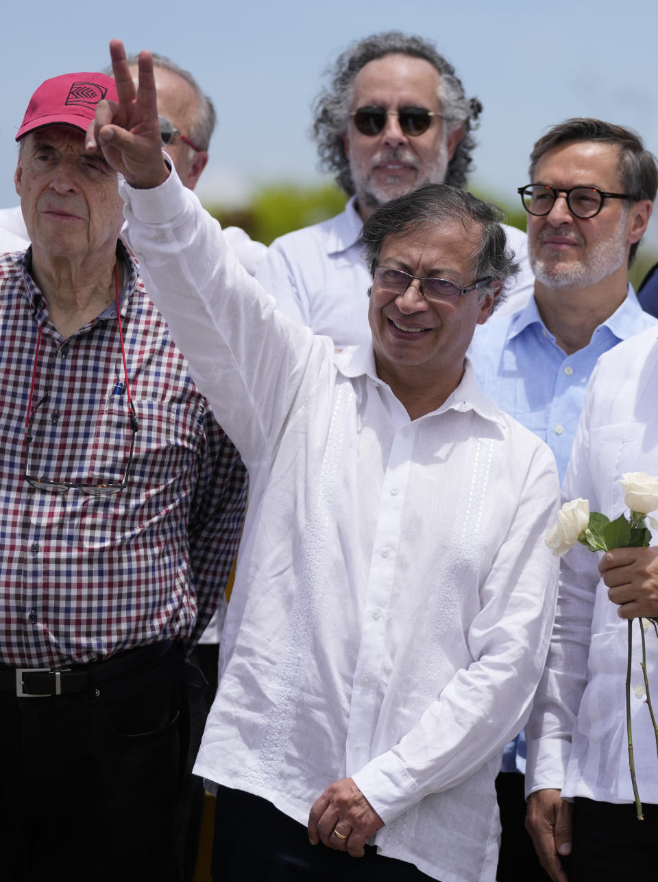 Colombia's President Gustavo Petro gestures a victory sign on the Simon Bolivar International Bridge during a ceremony to mark its reopening, between Cucuta, Colombia and San Antonio del Tachira, Venezuela, Monday, Sept. 26, 2022. Vehicles with merchandise will cross the bridge on Monday in a ceremonial act to seal the resumption of commercial relations between the two nations. (AP Photo/Fernando Vergara)