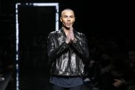 French fashion designer Olivier Rousteing acknowledges applause at the end of Balmain's Men fall-winter 2017-2018 fashion collection presented in Paris, Saturday, Jan. 21, 2017. (AP Photo/Francois Mori)