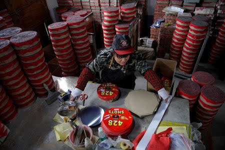 A worker wraps up pyrotechnic product at Liuyang Standard Fireworks Manufactory in Liuyang, Hunan province, China January 29, 2018, Picture taken January 29, 2018. REUTERS/Aly Song