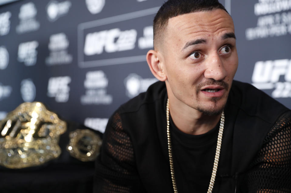 UFC featherweight champion Max Holloway takes a 12-fight win streak into his title defense against Brian Ortega. (AP)