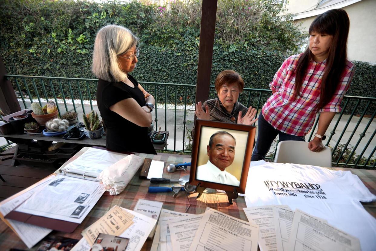 A family stands next to memorabilia from their shuttered restaurant.