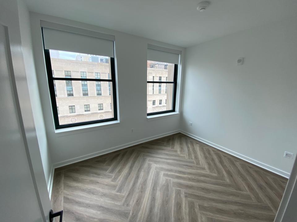 The empty bedroom at The Press/321 with two large windows