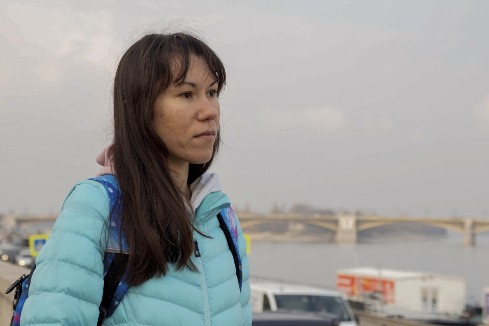 Olena, a Russian citizen fleeing from Kyiv, Ukraine (no family name given for safety reason) stands near the River Danube in downtown Budapest on Friday, March 4, 2022. Olena who years ago left her home country in opposition to Vladimir Putin's government has been forced to flee again — this time from her adopted home of Kyiv — as Putin's armed forces assault Ukraine. (AP Photo/Balazs Kaufmann)