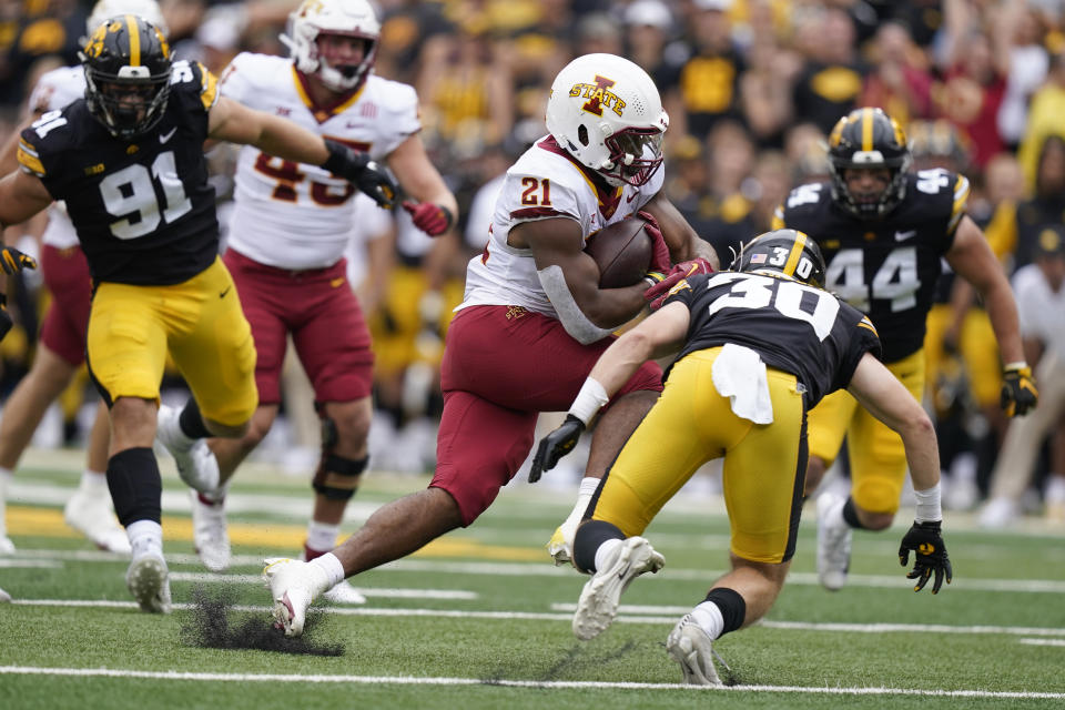 Iowa State running back Jirehl Brock (21) runs from Iowa defensive back Quinn Schulte (30) during the first half of an NCAA college football game, Saturday, Sept. 10, 2022, in Iowa City, Iowa. (AP Photo/Charlie Neibergall)