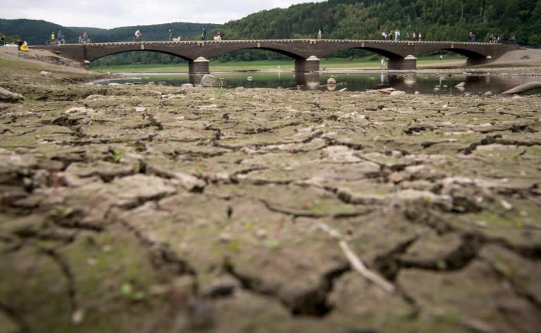 Pedestrians cross the Aseler Bridge over the partially dried out Edersee lake in Asel-Sued, in central Germany