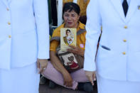 A woman holds an image of King Maha Vajiralongkorn during his coronation in Bangkok, Thailand, May 4, 2019. REUTERS/Athit Perawongmetha