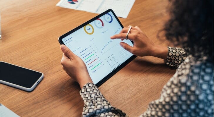 A woman looks over her portfolio on her tablet. John Hancock has launched a new preferred income ETF that invests heavily and preferred stock and other income-producing assets. 