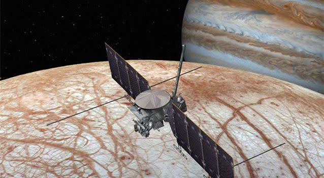 An artist’s impression of the Europa Clipper flyby probe hovering over the icy moon. Picture: NASA/JPL-Caltech