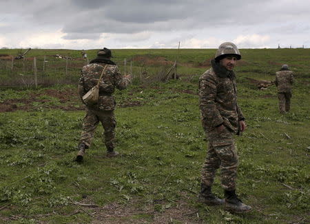 Soldiers of the self-defense army of Nagorno-Karabakh gather at their positions in Martakert province, which according to Armenian media was affected by clashes over the breakaway Nagorno-Karabakh region, April 4, 2016. REUTERS/Vahan Stepanyan/PAN Photo