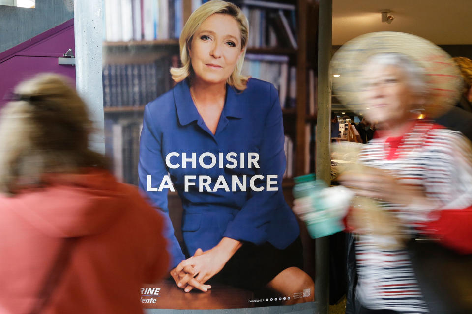 <p>Two women pass an election poster for French far-right leader and presidential candidate Marine Le Pen which reads “Choose France” prior to an election campaign rally in Nice, southern France, Thursday April 27, 2017. After “the battle of Whirlpool,” when Marine Le Pen and Emmanuel Macron both went hunting for France’s blue-collar vote at a threatened home appliance factory, the presidential candidates clashed over fish as Le Pen boarded a fishing trawler, in a return to more traditional campaigning on Thursday. (AP Photo/Claude Paris) </p>