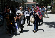<p>Afghan women run away after a blast and gun fire at the site of an attack in Kabul, Afghanistan July 31, 2017. (Mohammad Ismail/Reuters) </p>