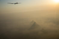 <p>Egypt’s pyramids peek out of a cloud of dust as Solar Impulse 2 flies high above them. (Solar Impulse/Revillard/Rezo.ch)</p>