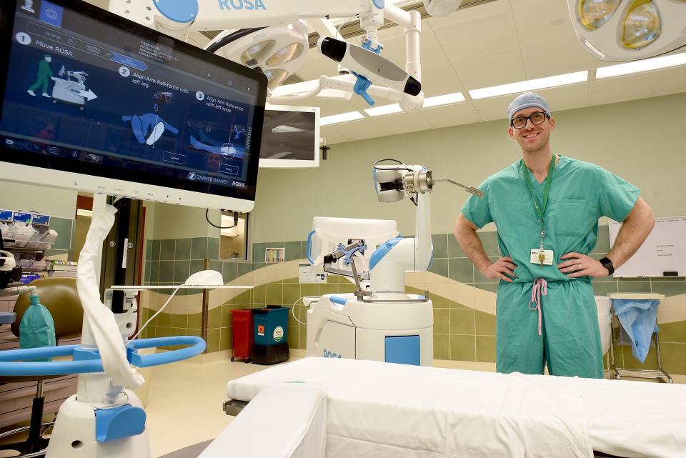 Surgeon Dr. Mark Zekaj is shown with ProMedica Monroe Regional Hospital's new robotic device that is used for orthopaedic surgeries. The local hospital has been using the device since November.