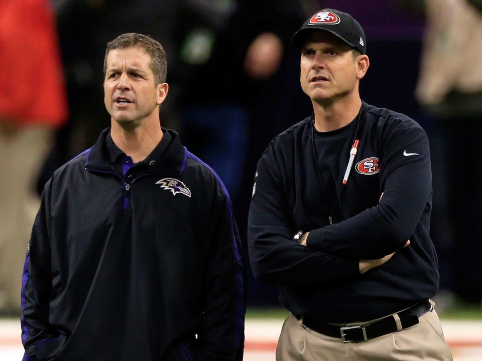 <p>Jamie Squire/Getty</p> John Harbaugh and Jim Harbaugh speak during warm ups prior to Super Bowl XLVII on February 3, 2013 in New Orleans, Louisiana.