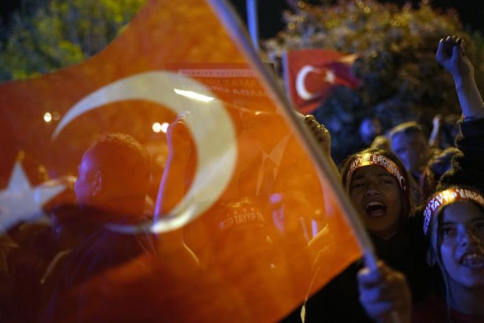 Supporters of President Recep Tayyip Erdogan shout slogans outside the headquarters of AK Party in Istanbul, Turkey, Sunday, May 14, 2023. More than 64 million people, including 3.4 million overseas voters, were eligible to vote. (AP Photo/Francisco Seco)