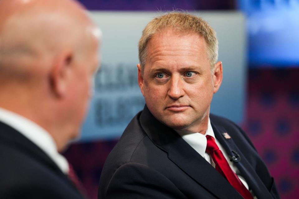 Nicholas Myers (right) speaks with Kevin Thompson before a debate for the office of Arizona Corporation Commissioner on  June 22, 2022, in Phoenix.