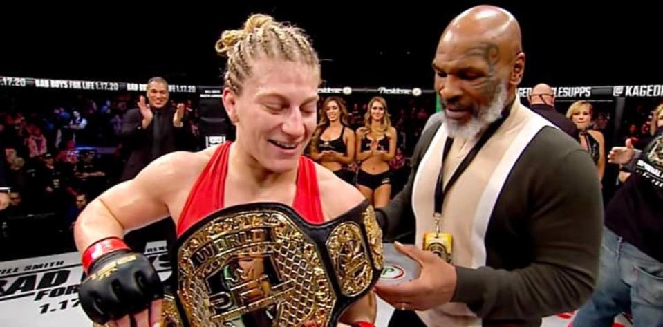 Boxing great Mike Tyson presents ATT’s Kayla Harrison with her PFL championship belt in 2019.