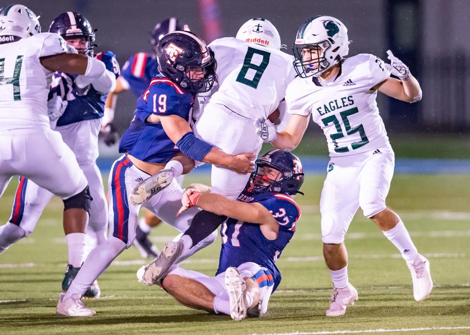 Carter Fontenot (19) and Owen deBoisblanc of Teurlings make the tackle during Friday's win over Shaw. The Rebels play district and city rival Lafayette Christian on Friday for a spot in the state championship.