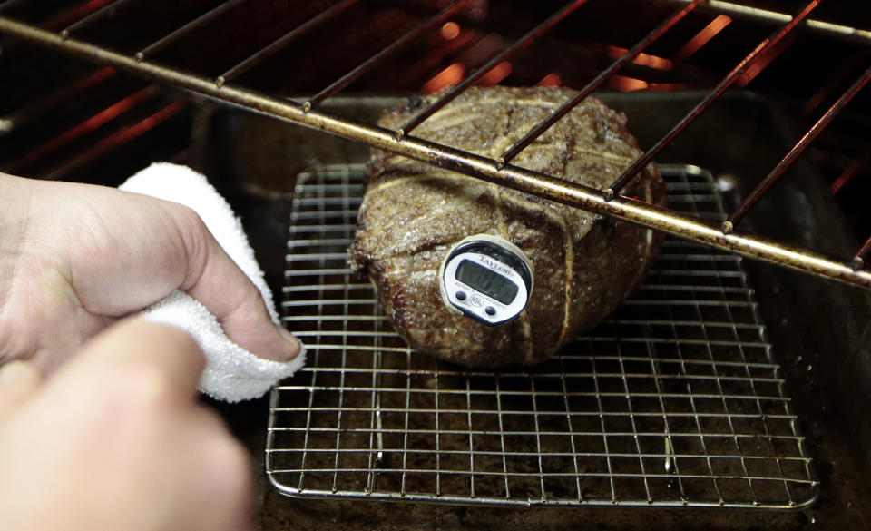 In this Dec. 11, 2013 photo, a beef top round, tied with pork back fat, is cooked as the final step in the process of preparing the "spiced round," a Christmastime beef specially, at the Porter Road Butcher in Nashville, Tenn. The specialty meat, reminiscent of corned beef, has all but disappeared in recent decades amid changing tastes and the steady decline of local butchers to prepare it. (AP Photo/Mark Humphrey)