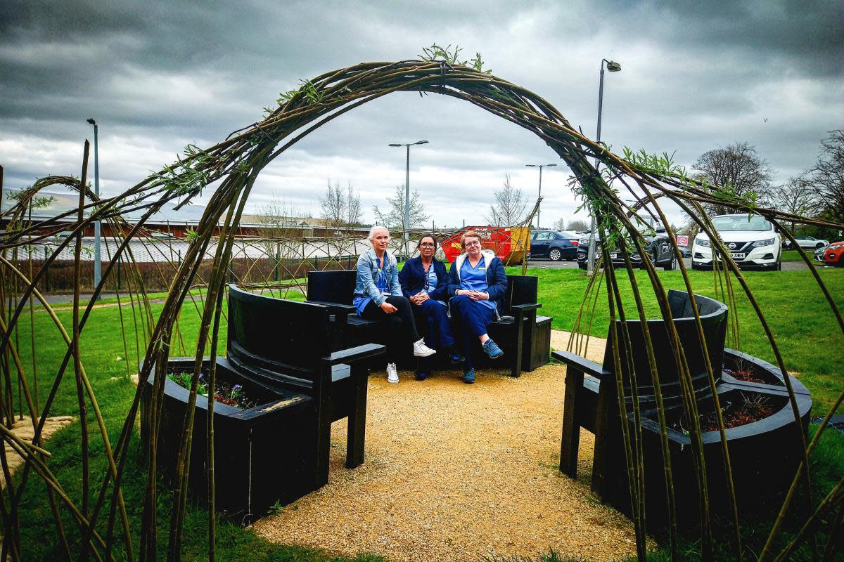 Enjoying the new outdoor space arch are, from left, Registered Nurse Emma Harper, Support Worker Audrey Duncan and Registered Nurse Charanne Edgar, all members of the TAN (Therapeutic Activity Nursing) Team at the Mental Health Campus <i>(Image: NHSGGC)</i>