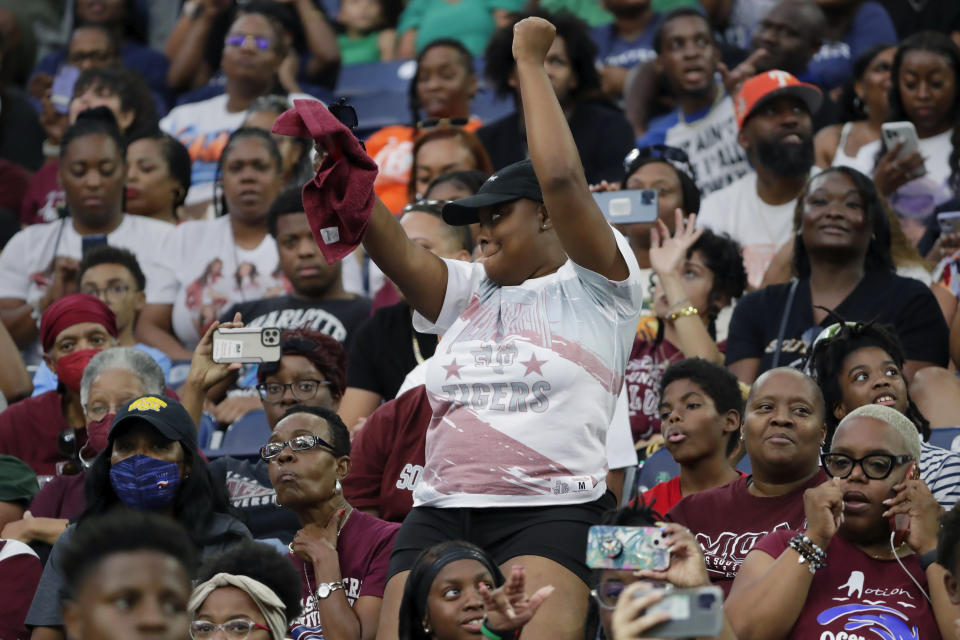 A fan in the stands dances as the Texas Southern University Ocean of Soul marching band performs during the 2023 National Battle of the Bands, a showcase for HBCU marching bands, held at NRG Stadium, Saturday, Aug. 26, 2023, in Houston. (AP Photo/Michael Wyke)