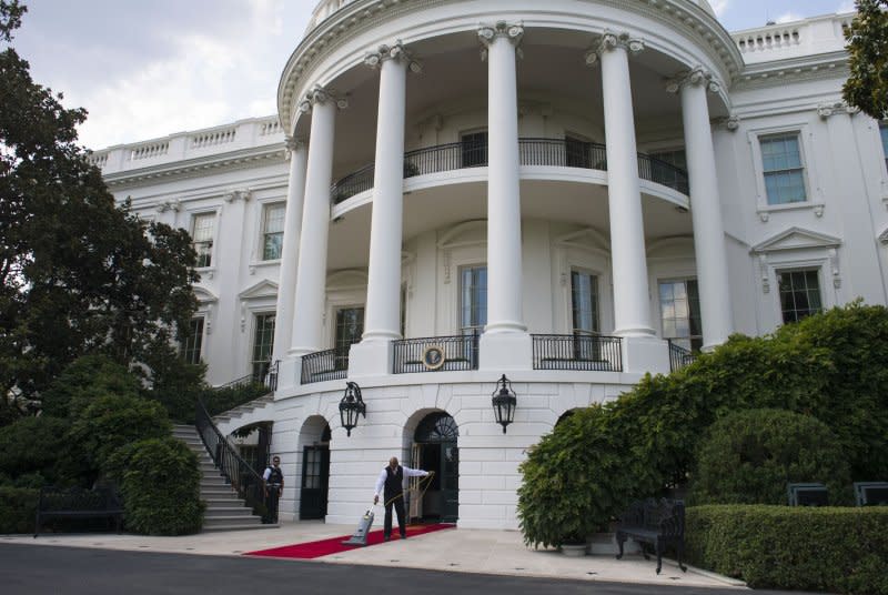 An usher vacuums a red carpet at the White House in Washington, D.C., on June 29. On September 9, 1893, first lady Frances Folsom Cleveland gives birth to a daughter in the White House. Esther Cleveland was the first child of a president to be born in the residence. File Photo by Kevin Dietsch/UPI