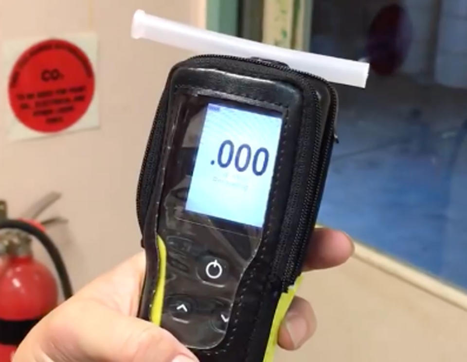 WA trucker Heather Jones shows her breath test before taking a bite of a hot cross bun. Source: Facebook/ Pilbara Heavy Haulage Girls Inc.