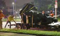 <p>Workers remove a monument dedicated to the Confederate Women of Maryland early Wednesday, Aug. 16, 2017, after it was taken down in Baltimore. Local news outlets reported that workers hauled several monuments away early Wednesday, days after a white nationalist rally in Virginia turned deadly. (Jerry Jackson/The Baltimore Sun via AP) </p>