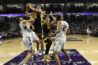 Iowa guard Joe Wieskamp (10) grabs a rebound in front of Northwestern center Ryan Young, left, during the second half of an NCAA college basketball game Tuesday, Jan. 14, 2020, in Evanston, Ill. (AP Photo/David Banks)