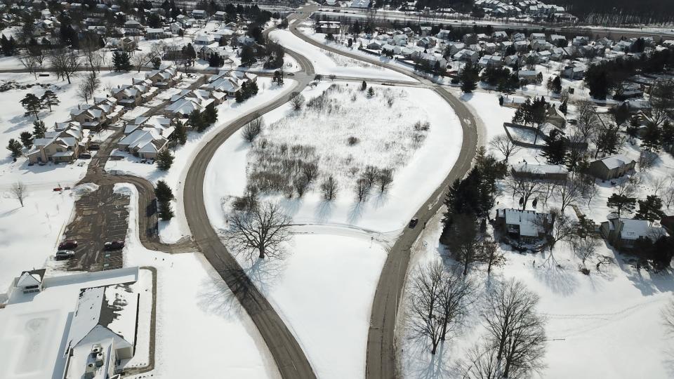 Some residents around Little Turtle Way are upset that a road improvement project will eliminate the wide greenspace between the northbound and southbound lanes. This view looks south; Route 161 is across the top of the picture.