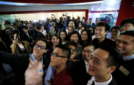 Hong Kong leader-elect Carrie Lam (C) attends a group selfie with students from Hong Kong after a news conference in Beijing, China April 11, 2017. REUTERS/Jason Lee